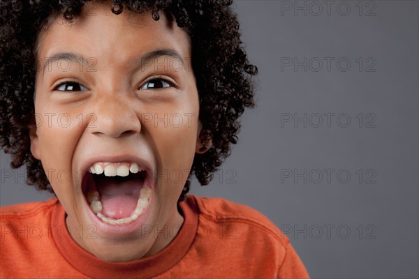 Studio portrait of boy (8-9) screaming. Photo : Rob Lewine