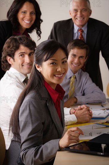 People at business meeting looking at camera. Photo : Rob Lewine