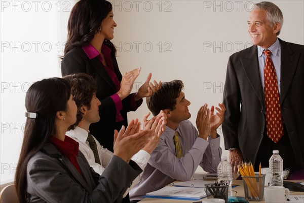 People at business meeting clapping. Photo : Rob Lewine