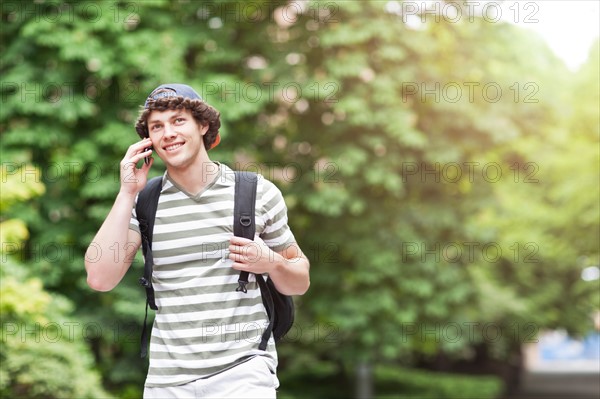 Male college student talking on cell phone. Photo: Take A Pix Media