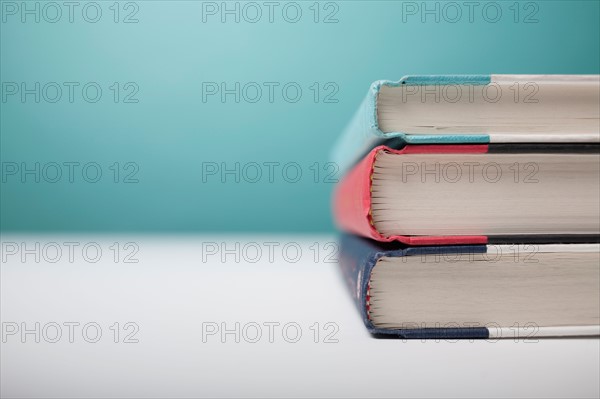 Studio shot of three books in stack. Photo : Winslow Productions