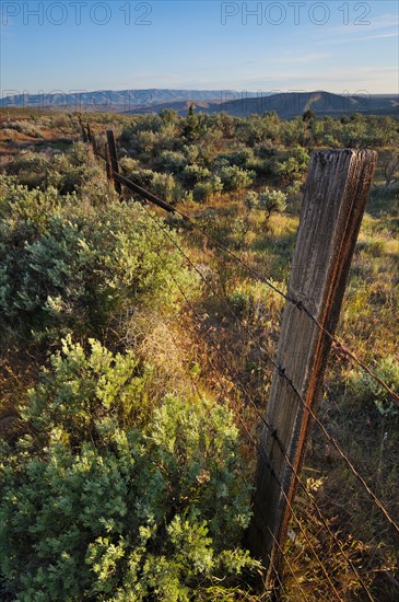 USA, Oregon, Old fence in desert. Photo: Gary J Weathers