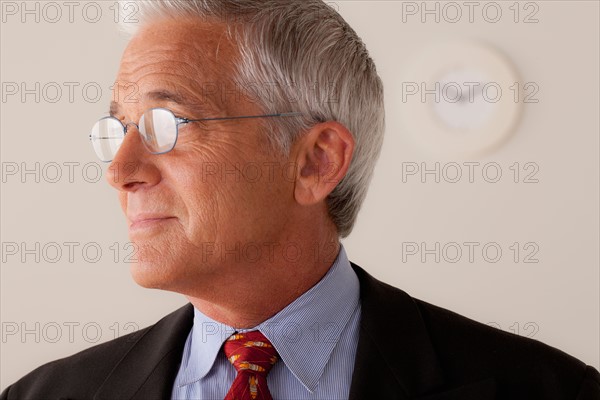 Studio portrait of senior businessman. Photo : Rob Lewine