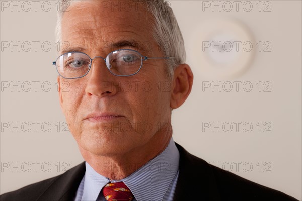 Studio portrait of senior businessman. Photo : Rob Lewine