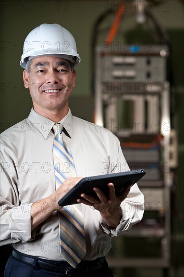 Portrait of male technician wearing hardhat. Photo : db2stock