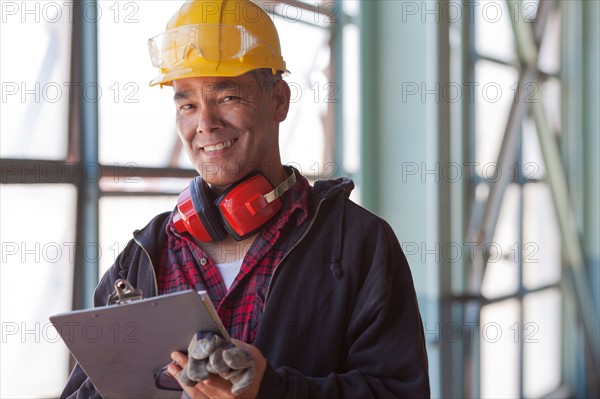 Portrait of male manual worker wearing hardhat. Photo : db2stock