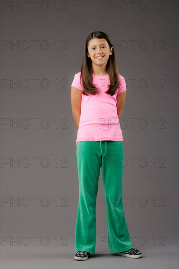 Portrait of smiling girl (8-9), studio shot. Photo : Rob Lewine