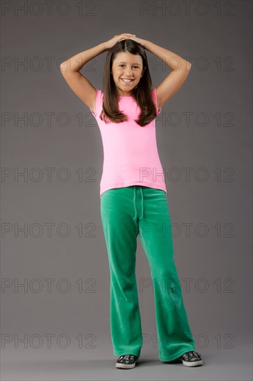 Portrait of smiling girl (8-9), studio shot. Photo : Rob Lewine