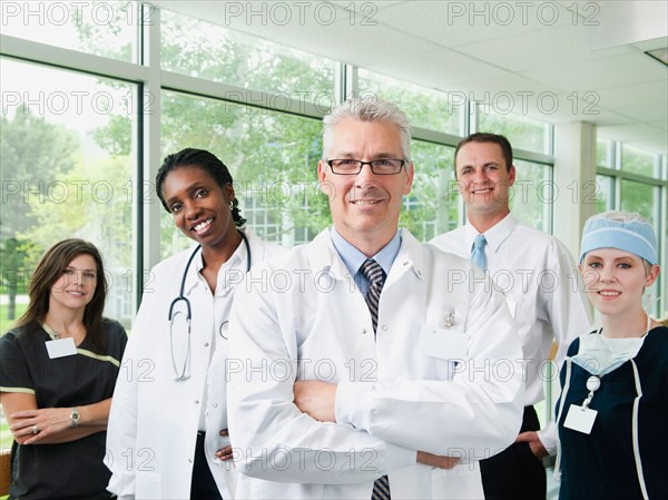 Male and female doctor, hospital manager and nurse posing for portrait.