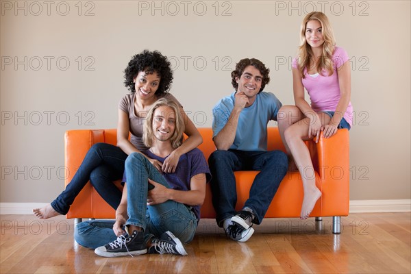Portrait of two couples sitting on sofa. Photo: Rob Lewine