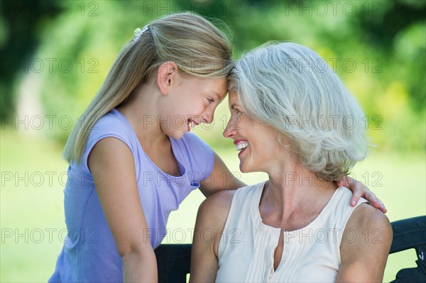 Grandmother with granddaughter (10-11) looking at each other.