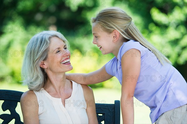 Grandmother with granddaughter (10-11) looking at each other.