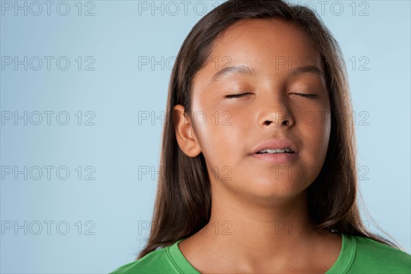 Studio portrait of girl (10-11) with closed eyes. Photo: Rob Lewine