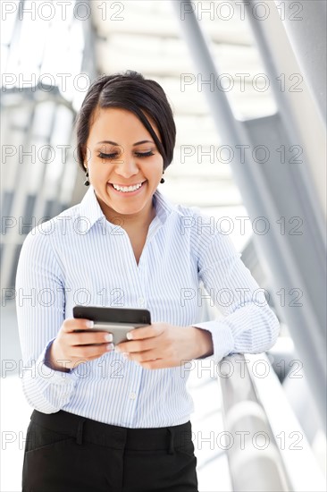 Young businesswoman text-messaging. Photo: Take A Pix Media