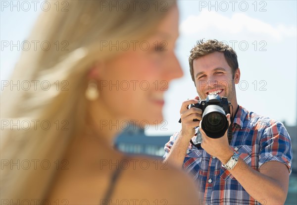 Photographer taking picture of woman.