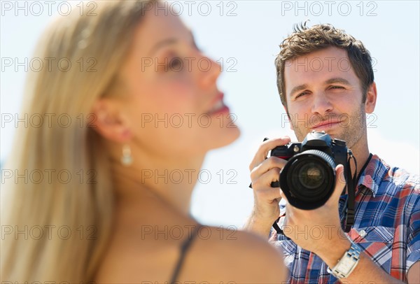 Photographer taking picture of woman.