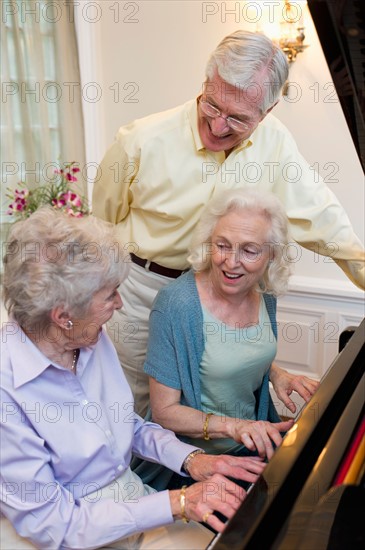 Seniors playing piano and singing.