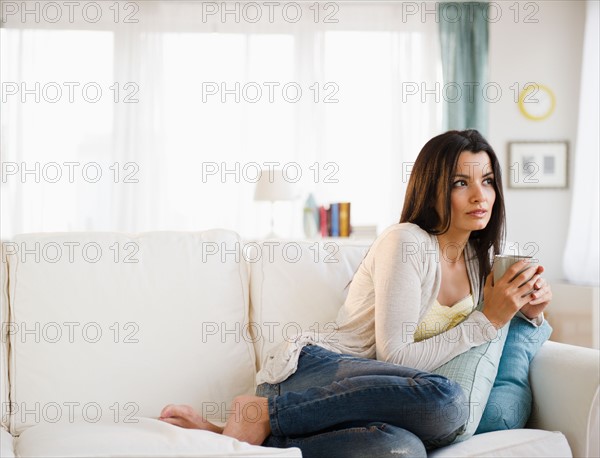 Woman relaxing on sofa . Photo : Jamie Grill