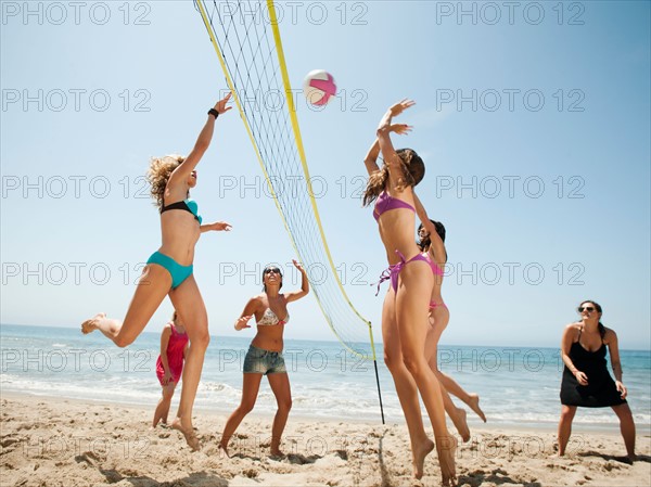 Group of young women playing beach volleyball . Photo: Erik Isakson
