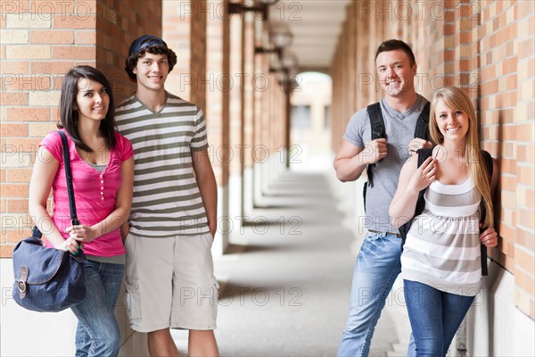 Portrait of four college students in corridor. Photo : Take A Pix Media