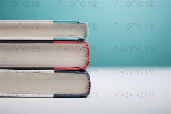 Studio shot of three books in stack. Photo : Winslow Productions