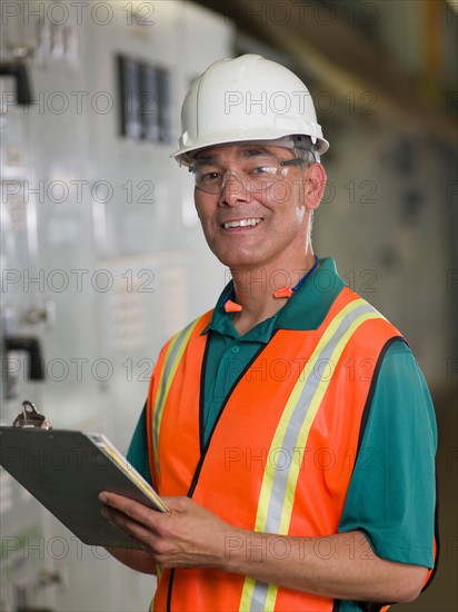 Portrait of industrial worker in hard hat. Photo : db2stock