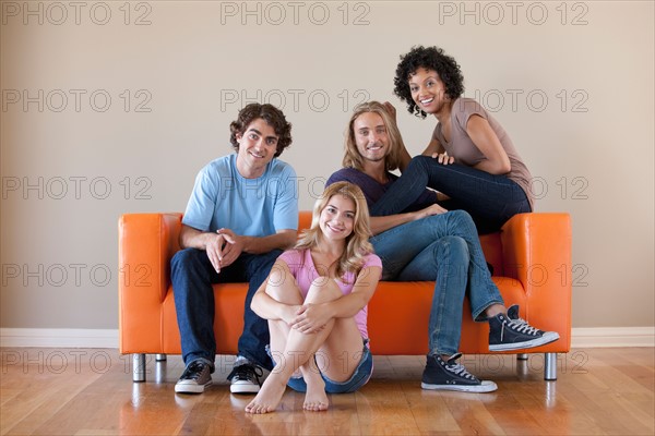 Portrait of two couples sitting on sofa. Photo : Rob Lewine