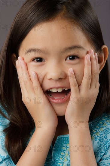 Portrait of surprised girl (8-9), studio shot. Photo: Rob Lewine