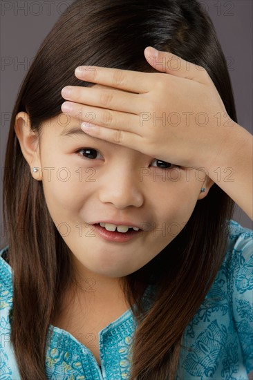 Portrait of surprised girl (8-9), studio shot. Photo : Rob Lewine