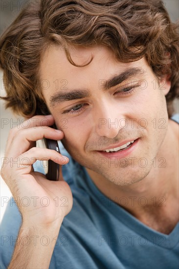 Portrait of young man talking on phone. Photo : Rob Lewine