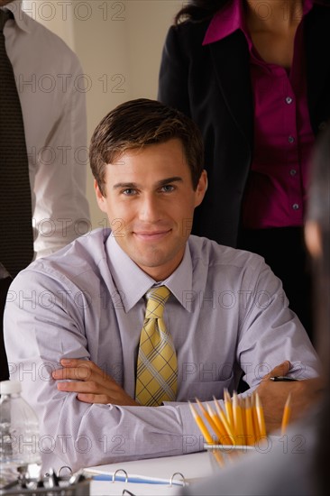 Portrait of smiling businessman in office. Photo : Rob Lewine