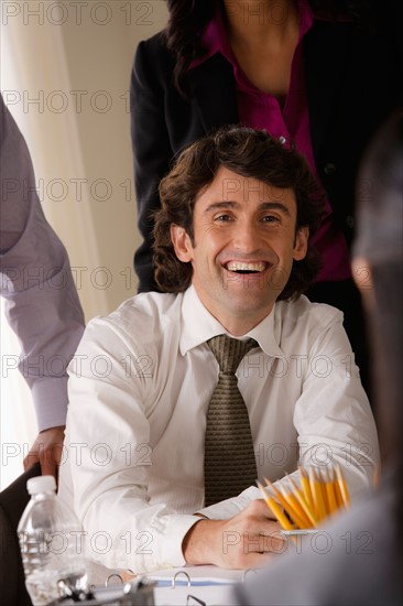 Portrait of smiling businessman in office. Photo : Rob Lewine