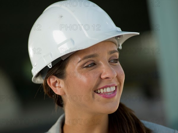 Portrait of woman wearing hardhat. Photo : db2stock