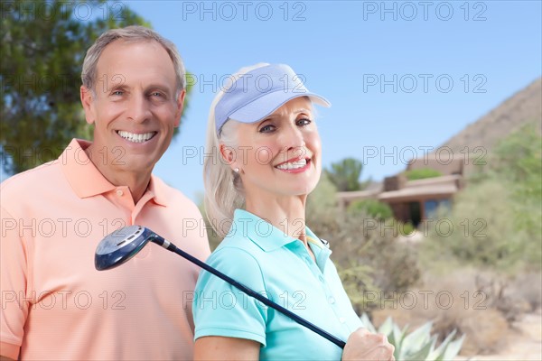 Portrait of couple on golf course. Photo: db2stock