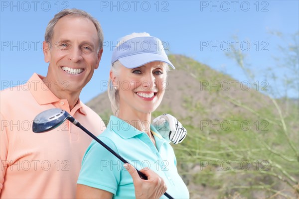 Portrait of couple on golf course. Photo : db2stock