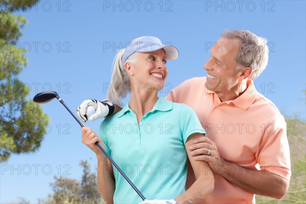 Portrait of couple on golf course. Photo: db2stock