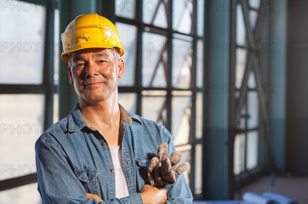 Portrait of worker wearing hardhat. Photo : db2stock