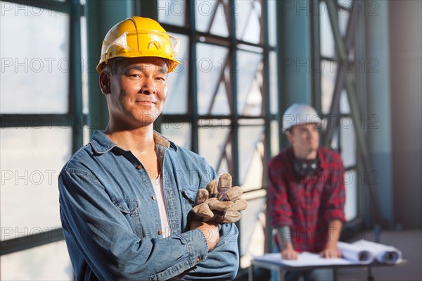 Portrait of worker wearing hardhat. Photo: db2stock