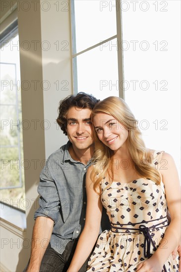 Portrait of young couple at home. Photo: Rob Lewine