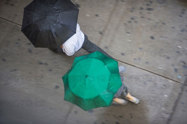 USA, New York State, New York City, Manhattan, People walking with umbrellas. Photo: fotog