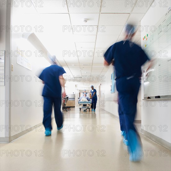 Medical team walking along hospital corridor before operation.