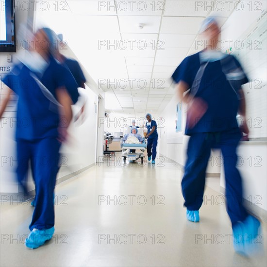 Medical team and patient moving towards operating room before surgery.