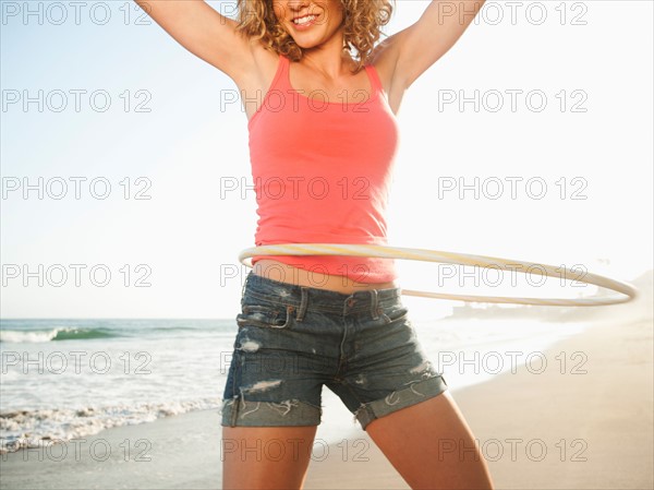 Young attractive woman exercising with hoola hoop. Photo: Erik Isakson