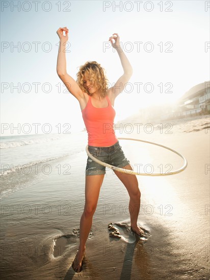 Young attractive woman exercising with hoola hoop. Photo: Erik Isakson