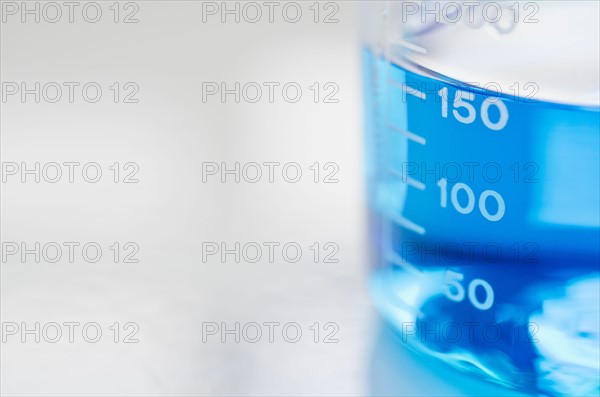 Studio shot of laboratory beaker with blue liquid. Photo: Antonio M. Rosario