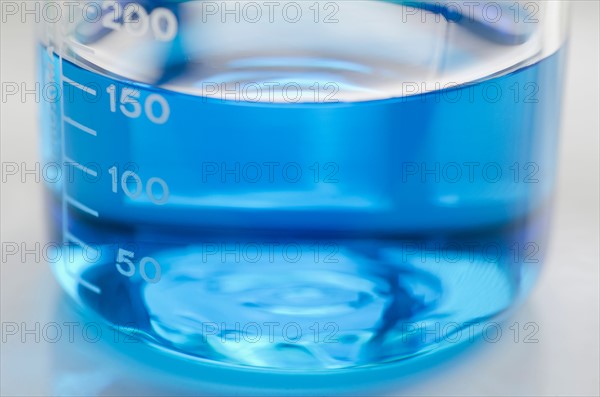 Studio shot of laboratory beaker with blue liquid. Photo : Antonio M. Rosario