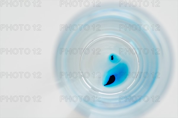 Studio shot of laboratory beaker with blue liquid. Photo : Antonio M. Rosario