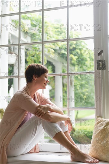 Woman looking through window.