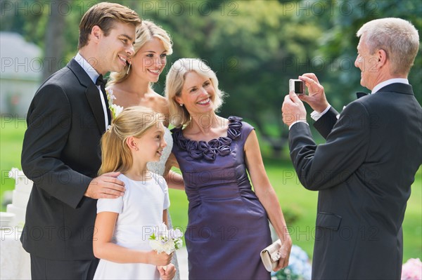 Married couple, parents and flower girl (10-11) posing.