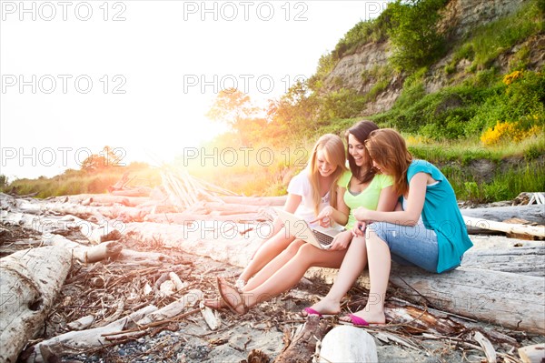 Three young women hanging out on beach. Photo: Take A Pix Media